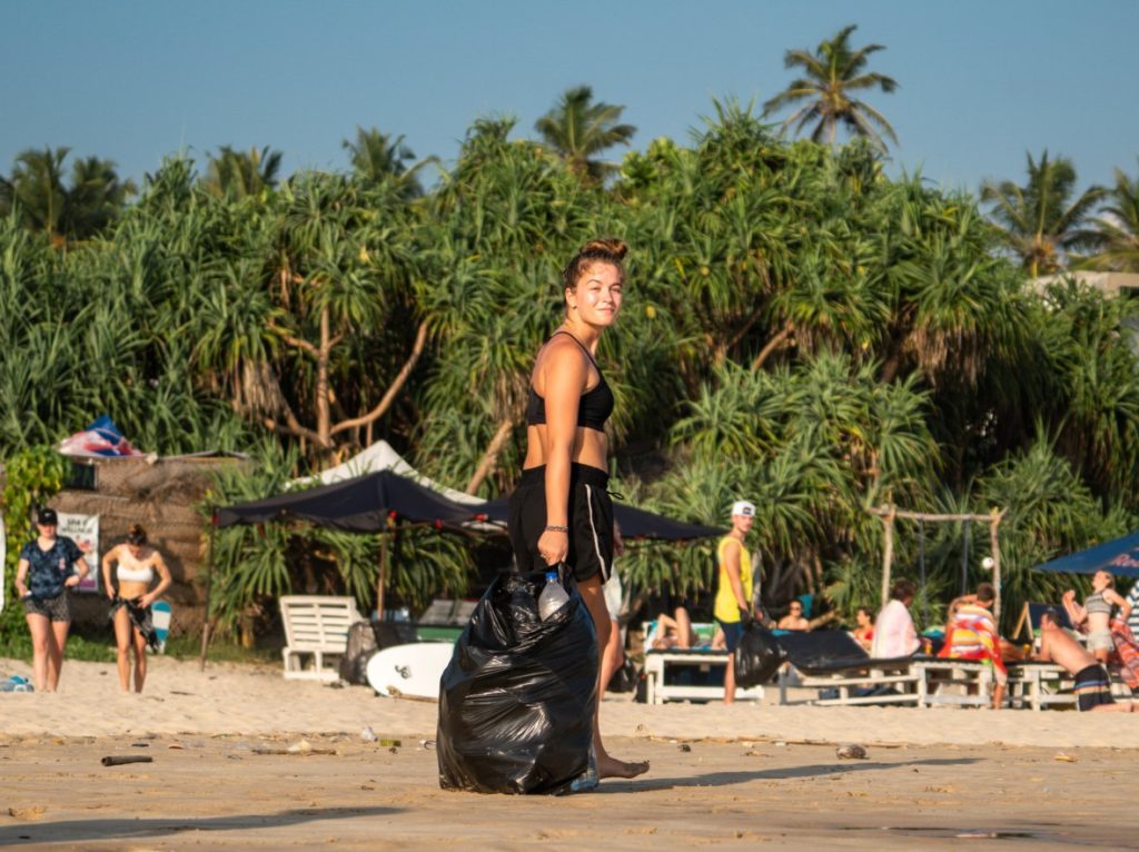 An image of a girl cleaning the beach