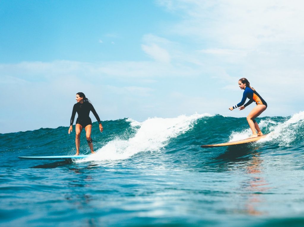 An image of surfing girls